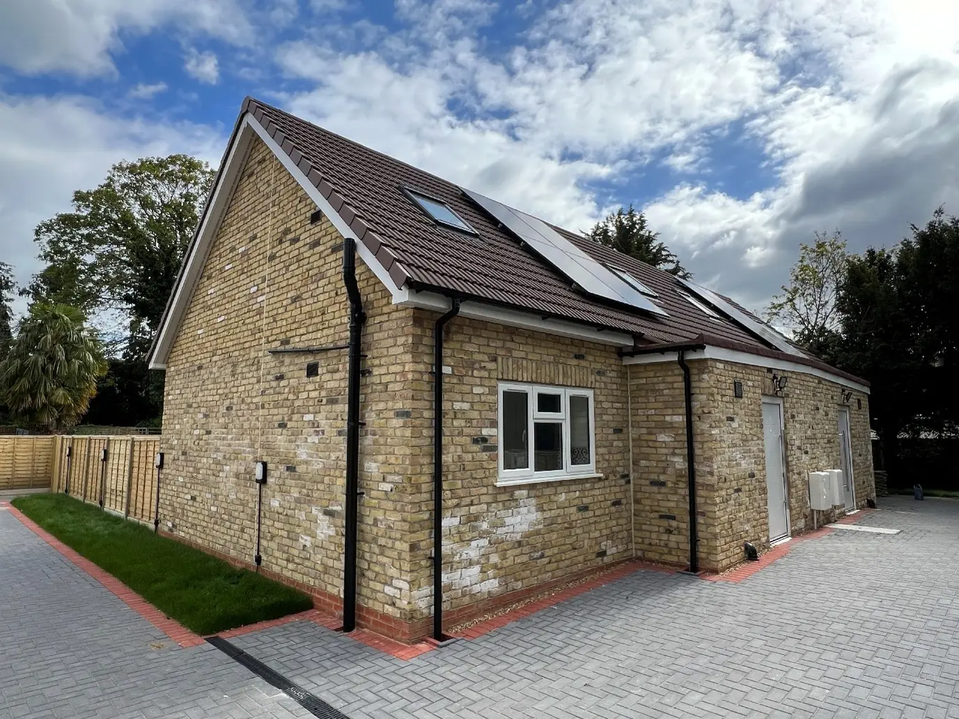 Gable end of one of the new semi-detached houses at Hanworth Road, with rooflights and solar panels
